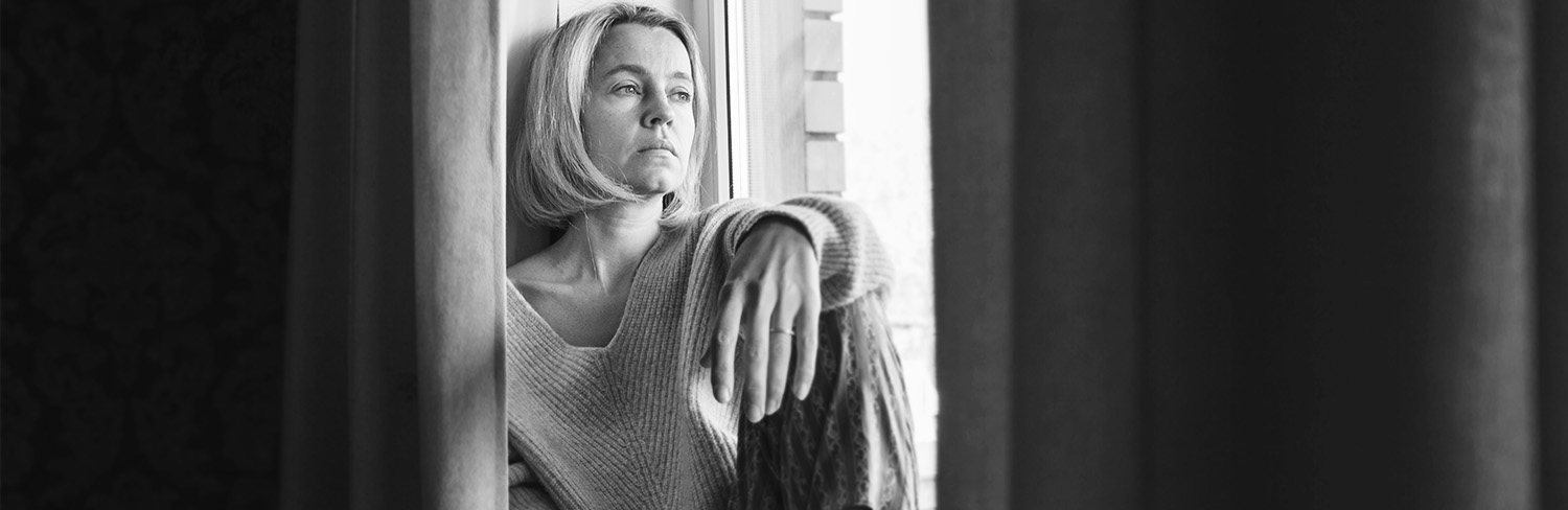 Adult woman look in window distance thinking or pondering alone at home