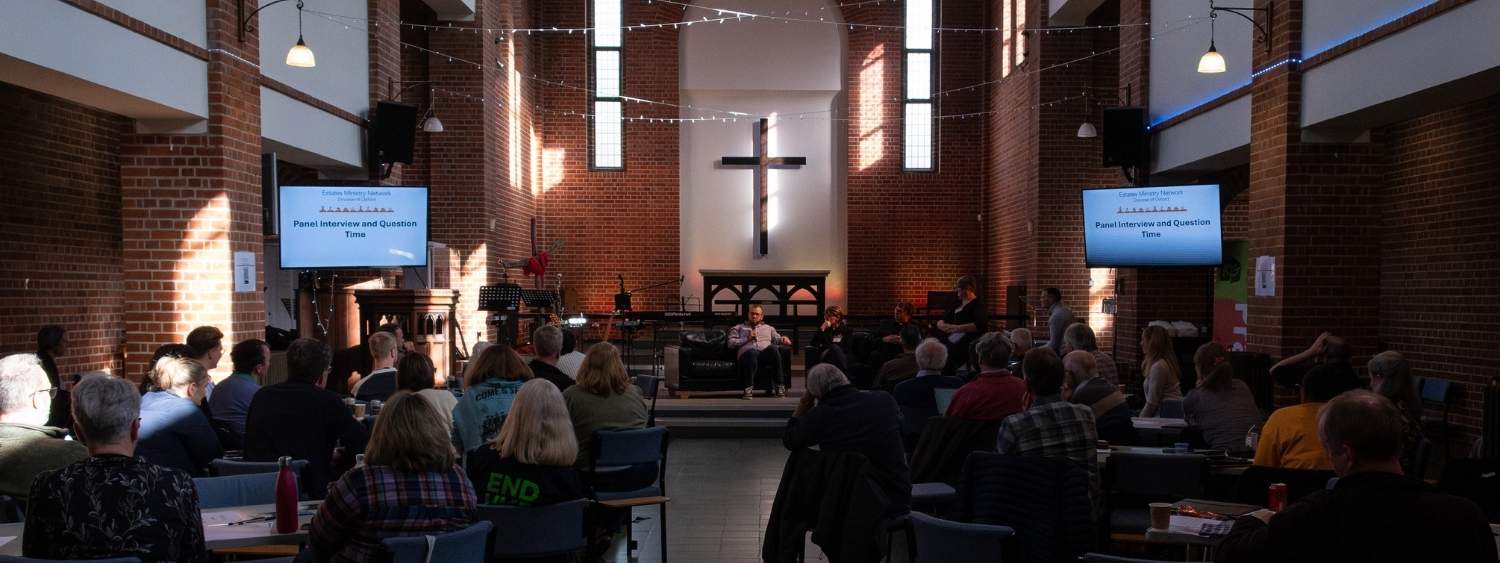 The inaugural estates ministry network conference at Reading Gateway Church - a panel of speakers sit on a sofa at the front of the church, looking back at the congregation and camera