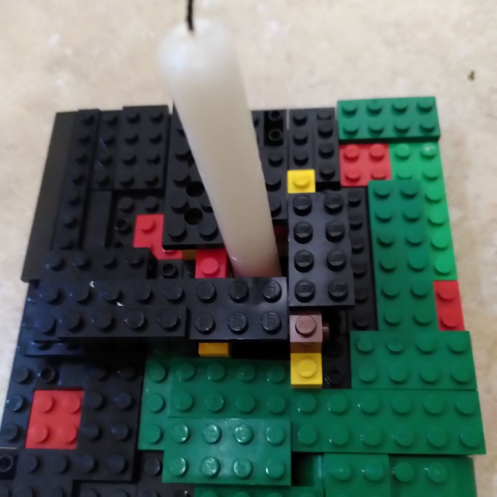 A Lego wreath holding a candle