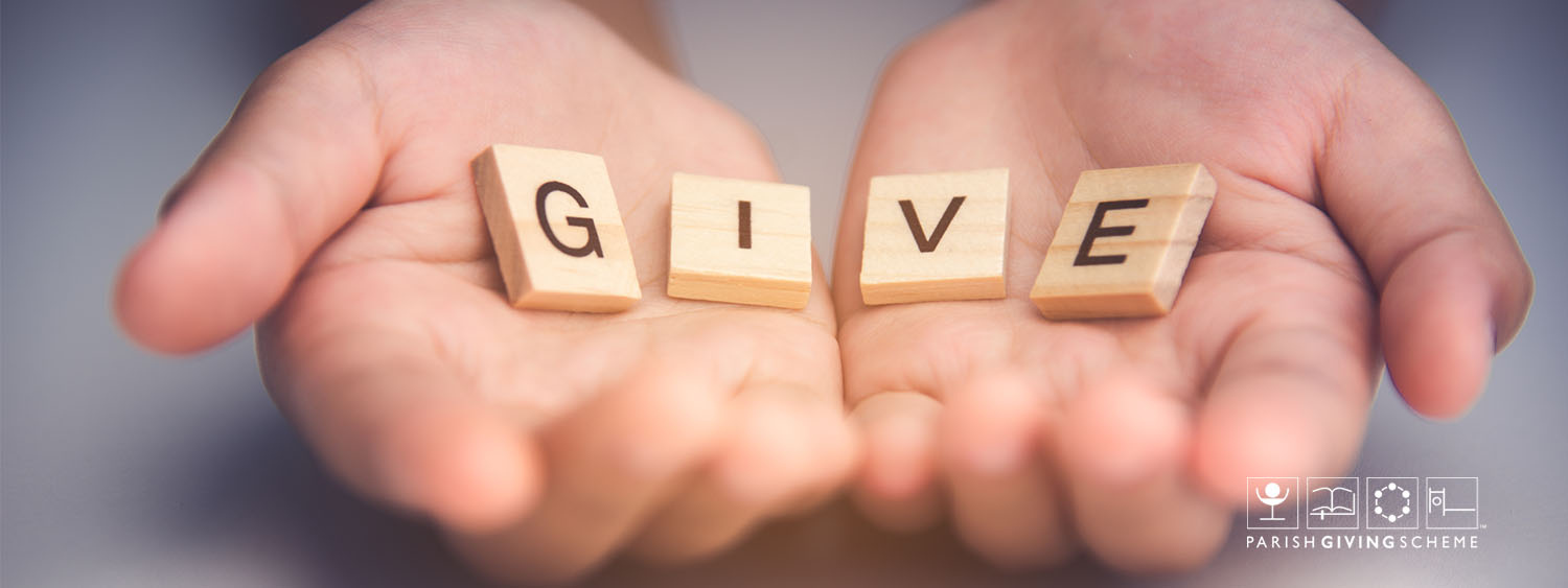 Two hands holding scrabble letters spelling out "Give"