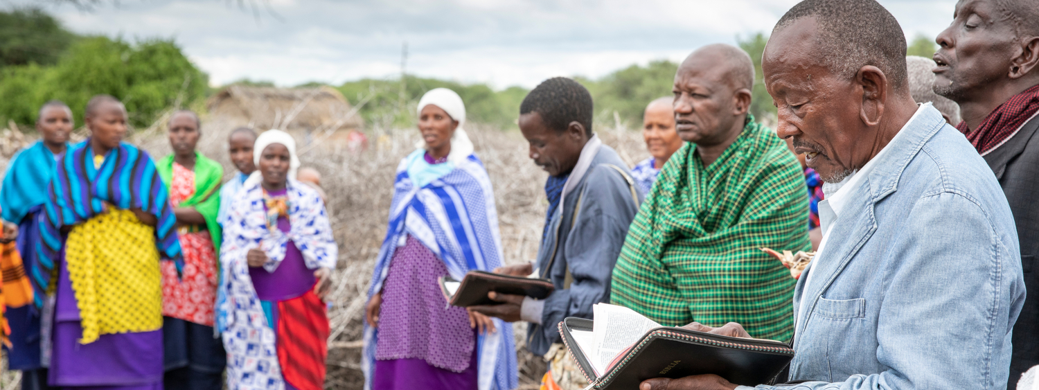 Maipo, Tanzania, 7th June 2019: maasai people reading a Bible and sing to worship God