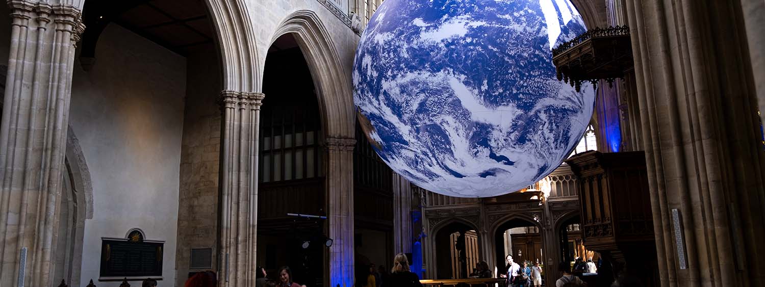 The Gaia art installation at the University Church, Oxford. A giant glowing globe is suspended within the church building