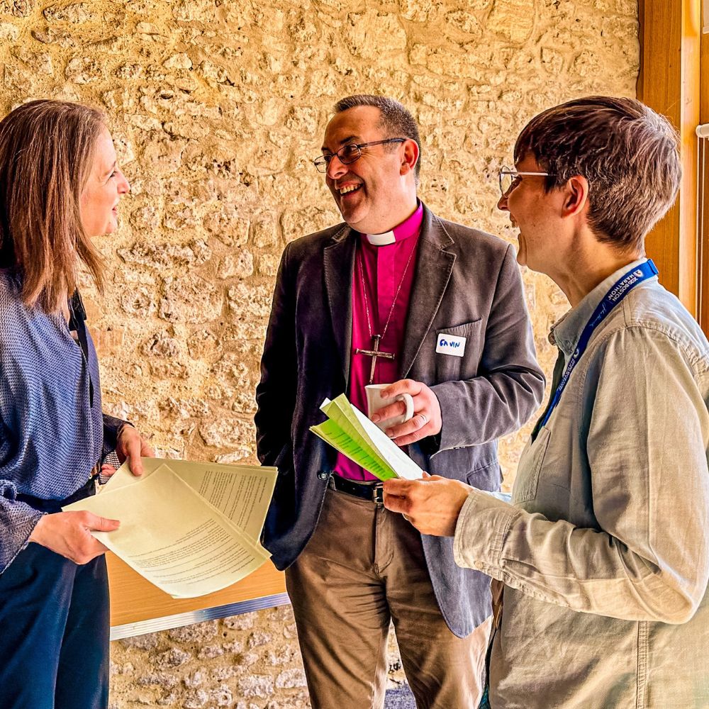 Bishop Gavin and Yvonne Morris stand talking to event speaker.