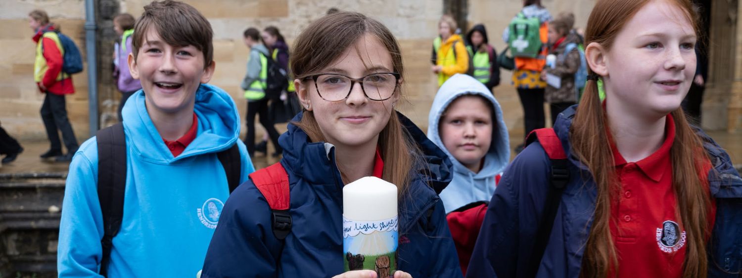 A school pupil holds a candle outside Christ Church Cathedral
